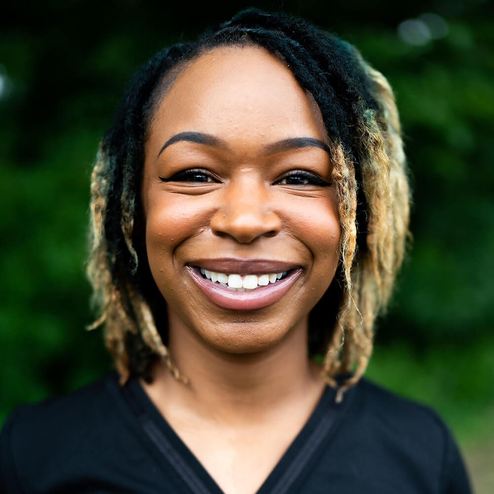 Sierra Perry, patient care coordinator, wearing a black shirt at Audiology Experts in Arlington, TX..