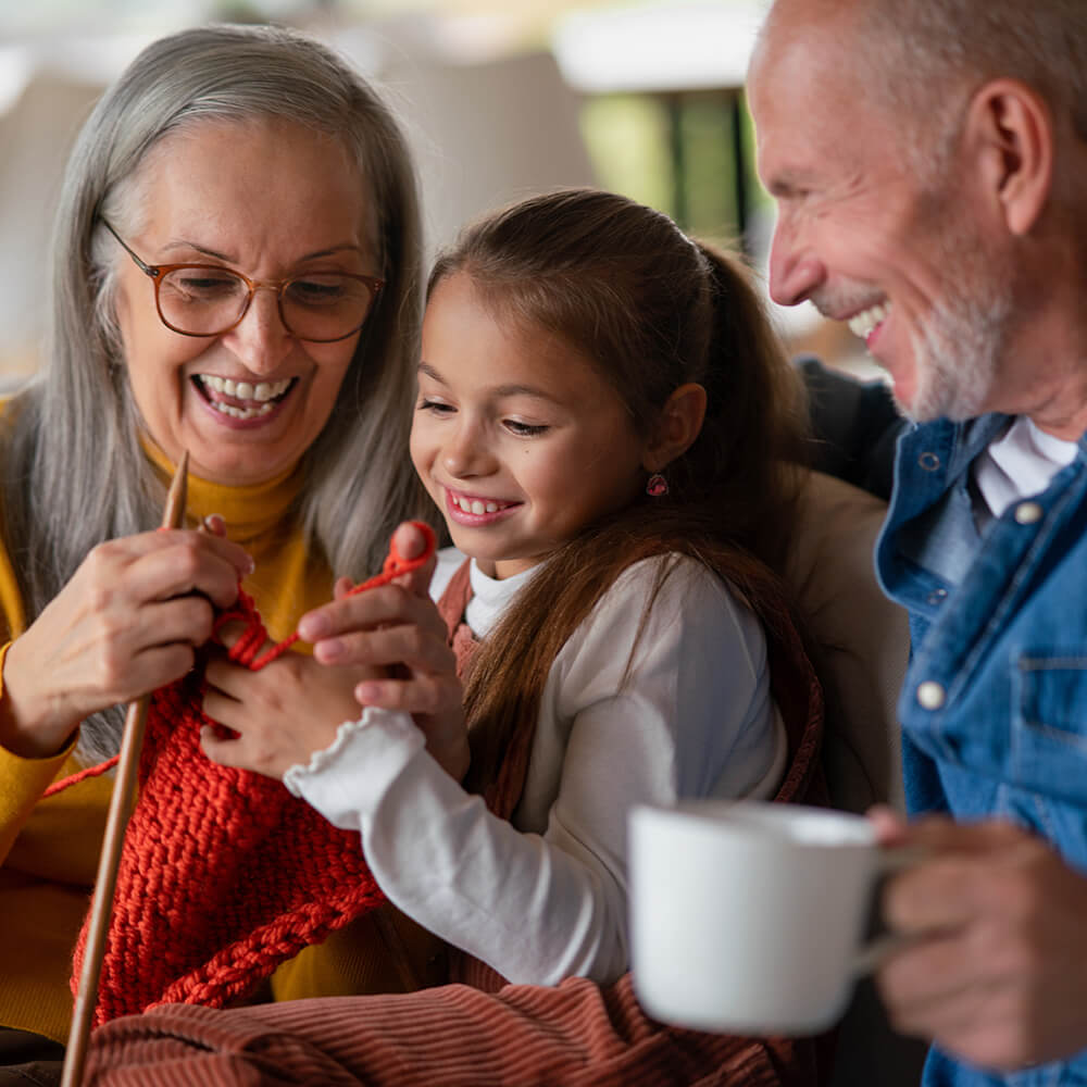 I grandmother teaching her granddaughter to knit.