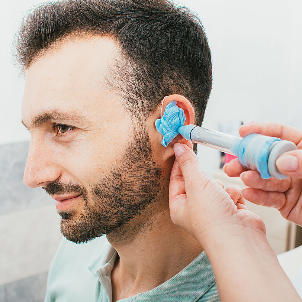 A male patient having an ear impression made for them.